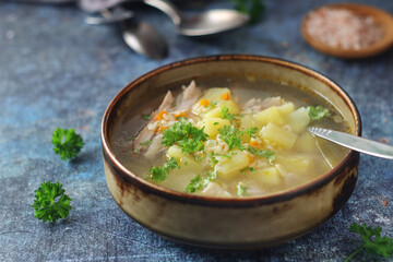 A bowl with chicken soup with pasta