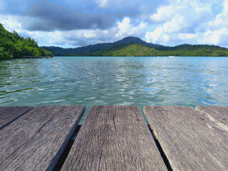 Panoramic view of the Caribbean sea with tropical vegetation and close-up of wooden pontoon sheets. Nature of the French Antilles.