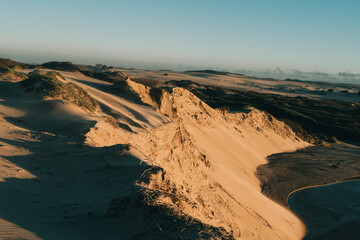 Dark and moody landscape. Sand dunes on the beach at sunset, California