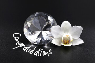 White orchid Phalaenopsis with a diamond . Text 'Congratulations'. Card marriage, wedding...