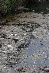 A giant floating rubbish heap floating in the river, plastic pollution, waste-clogged rivers. Huge environmental and health hazard. Problem of plastic that ends up in freshwater ecosystems.