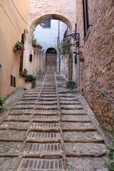Fototapeta na wymiar Stairs in a old narrow alley in Spello, Umbria Italy