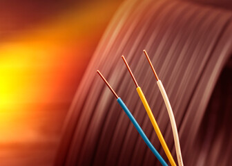 wooden, dark background. cable for wiring electrics in a country house and industrial facilities....