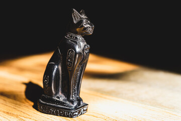 Egyptian black Bastet cat statue in the afternoon sun