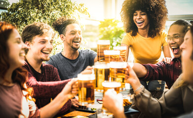 Multiracial friends drinking and toasting beer pint at brewery bar restaurant - Beverage life style...