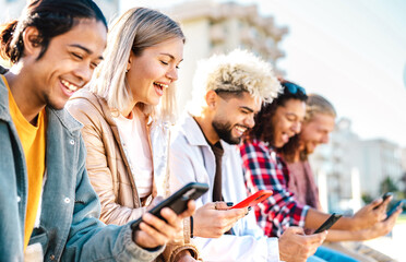 Trendy millenial friends using smartphone at campus college - Young genz people sharing live content with mobile smart phone - Tech life style concept with always connected millennials - Bright filter