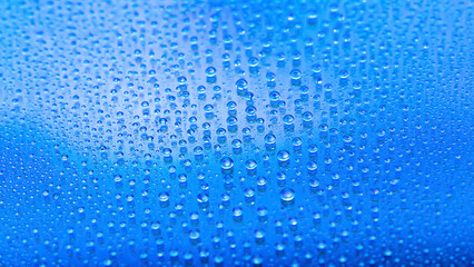 Fototapeta na wymiar Water drops. Abstract gradient background. Drop texture. Blue gradient. Heavily textured image. Shallow depth of field. Selective focus