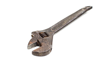 old rusty adjustable spanner on a white background is isolated