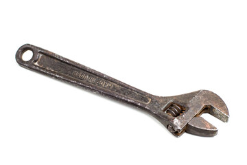 old rusty adjustable spanner on a white background is isolated