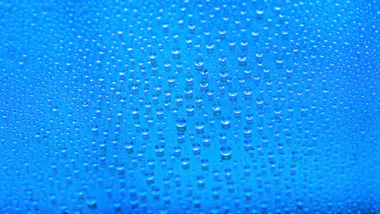 Naklejka na ściany i meble Water drops. Abstract gradient background. The texture of the drops. Blue gradient. Heavily textured image. Shallow depth of field. Selective focus