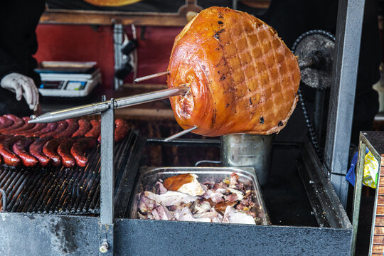 Traditional czech smoked ham prepared on open fire in Prague street