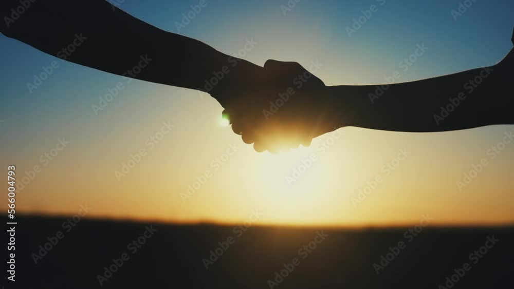 Wall mural handshake farmers silhouette. agriculture business concept. sun close-up farmers hands silhouette shaking hands silhouette making a contract agreement. farmers negotiations in agriculture business