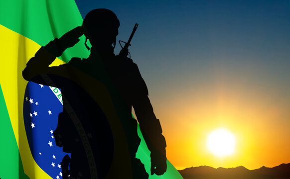 Silhouette of a saluting soldier against the sunset with Brazil flag. Armed Forces of Brazil concept. EPS10 vector