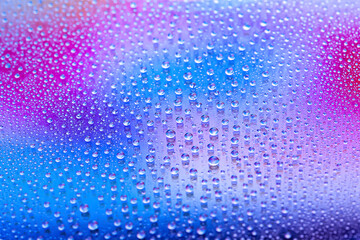 Water drops. Droplet texture. Abstract gradient background. Color rainbow gradient. Heavily textured image. Shallow depth of field. Selective focus