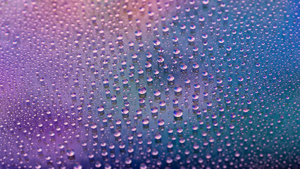 Water drops. Texture of the drops. Abstract gradient background. Multicolored blue purple rainbow gradient. Heavily textured image. Shallow depth of field. Selective focus