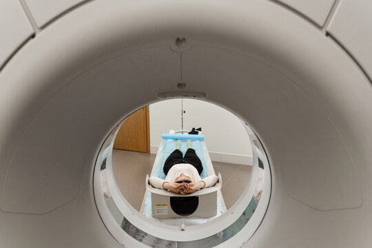 CT scan of abdomen of girl in medical clinic. Woman patient is doing computed tomography x-ray scan chest examination of abdominal in a CT scan room.