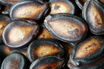 top view of melon seeds in a bowl on black background 