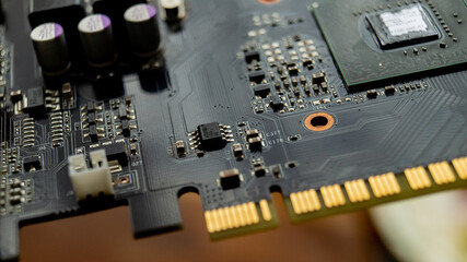 Electronic board with transistors and resistors. Printed circuit board. Transistors and resistors. Computer motherboard. Computer video card. Printed tracks of the electronic board