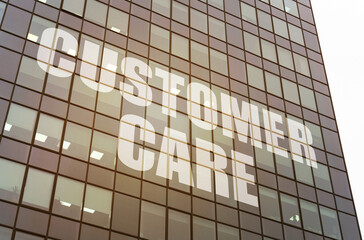 Fototapeta premium On the glass surface of the business center there is an inscription - Customer Care