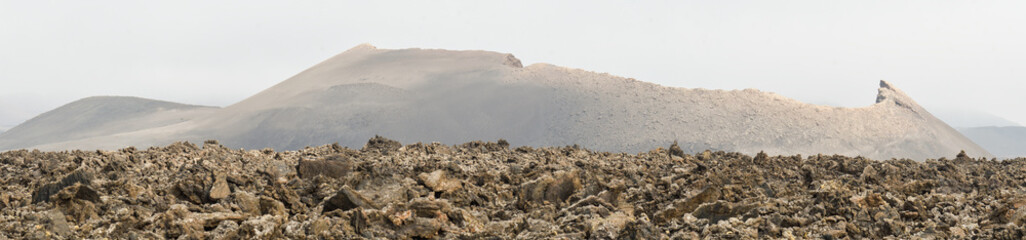 Old volcanic cone surrounded by lava in Tinajo, Lanzarote