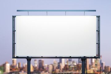 Blank white billboard on city buildings background at night, front view. Mockup, advertising concept