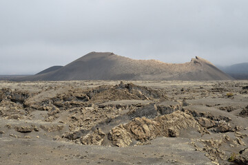 Old volcanic cone surrounded by lava in Tinajo, Lanzarote