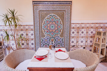 Oriental hospitality. Traveling by Morocco. Relaxing in festive moroccan traditional riad interior...