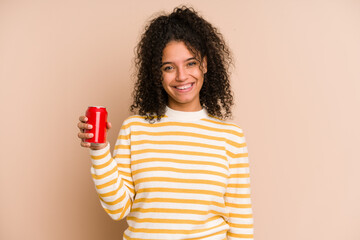 Young african american woman holding a cola refreshment isolated happy, smiling and cheerful.