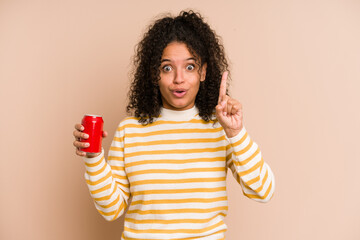 Young african american woman holding a cola refreshment isolated having some great idea, concept of creativity.