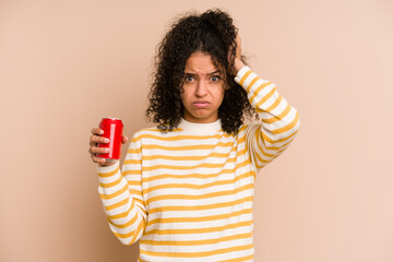 Young african american woman holding a cola refreshment isolated being shocked, she has remembered...