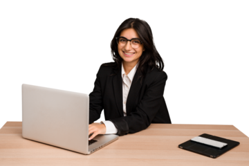 Young indian woman in a table with a laptop and tablet using a mobile phone isolated