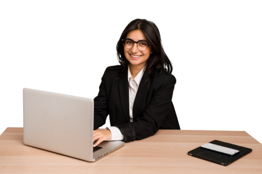 Young indian woman in a table with a laptop and tablet using a mobile phone isolated