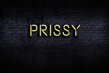 Night view of neon sign on brick wall with inscription prissy