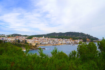 Fototapeta na wymiar view over pine trees and the mediterranean sea to the beautiful fishing town Callela de Palafrugell at the morning, Costa Brava, Catalonia, Spain