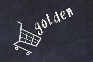 Chalk drawing of shopping cart and word golden on black chalboard. Concept of globalization and...