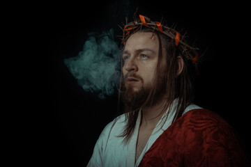 Jesus Christ smokes a cigarette wearing a crown of thorns and white chiton toga cape himation...
