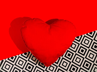 Minimal concept red pillow in the shape of a heart. Love idea on black and white background. Flat...