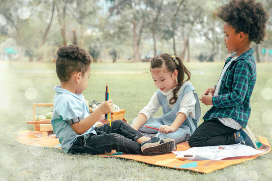 While the girl and a little boy were having fun drawing a picture together, the boy had to give the girl a snack.