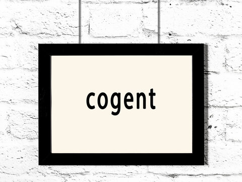 Black frame hanging on white brick wall with inscription cogent