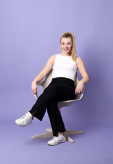 Beautiful blond woman sitting in a chair
