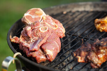 Cooking different meat on barbecue. Grilled and roasted lamb steaks on bbq