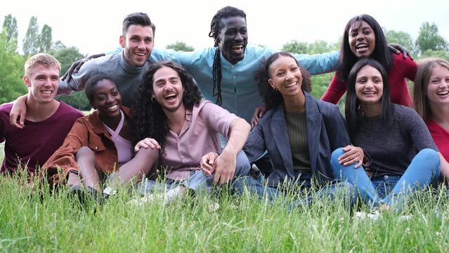 Video of friends from various backgrounds having a fun afternoon outdoors in the park. Concept: Lifestyle, friendship, diversity