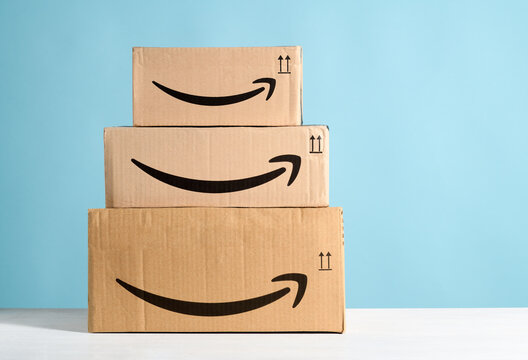 Group of Amazon cardboard boxes on a light blue background. Bergamo, Italy, 15 December 2022.