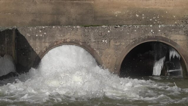 Slow motion of a dam water release, excess capacity of the dam after a heavy rain, storm in autumn