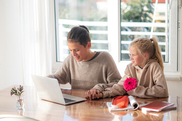 First love, young teens lovers couple studying laptop at home, holds hands, boy and girl doing homework, first dating, flower and kids love.