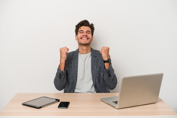 Young entrepreneur man working with a laptop isolated celebrating a victory, passion and...