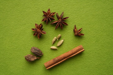 Assorted spices on a green background