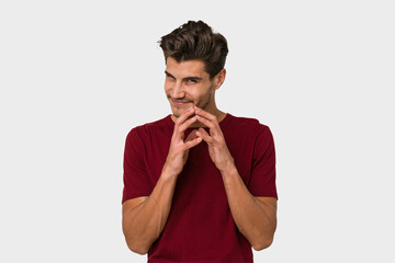 Young handsome caucasian man isolated on white background making up plan in mind, setting up an idea.