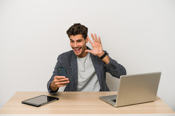 Young caucasian business entrepreneur man working with laptop, mobile phone and tablet