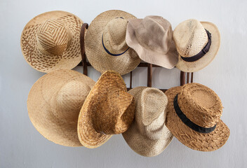 Rack cluttered with hats made from vegetable fibers